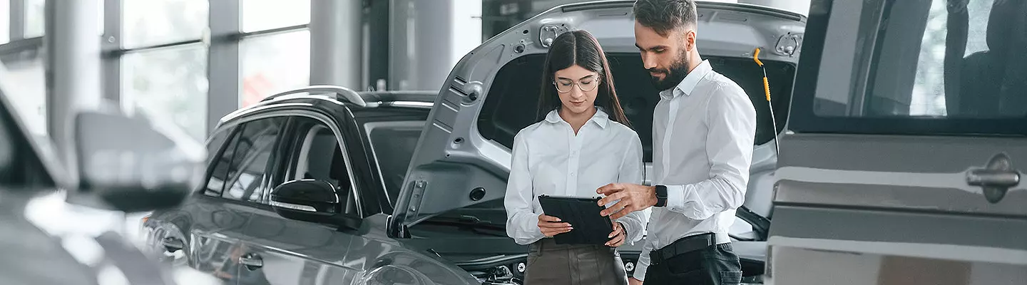 Service techs reviewing vehicle information on a tablet