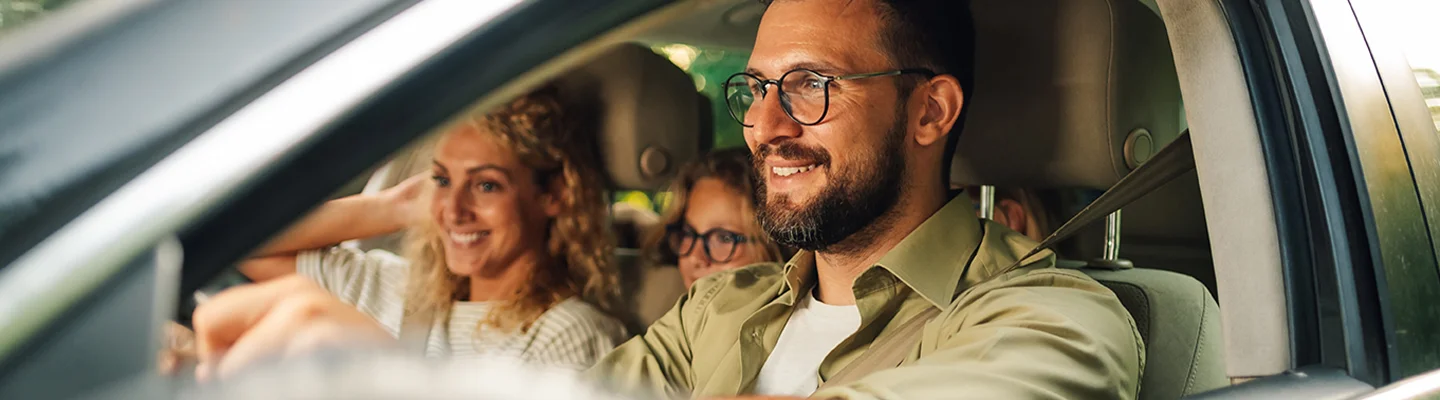 smiling man driving car