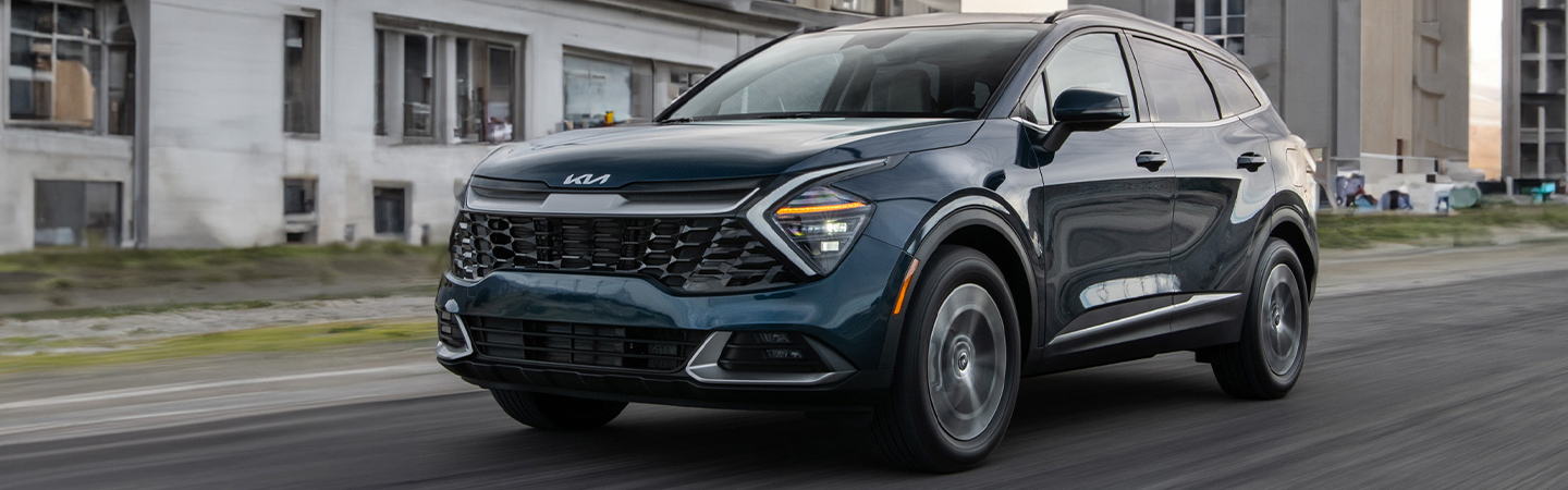 driver side view of a 2025 Kia Sportage Hybrid in motion