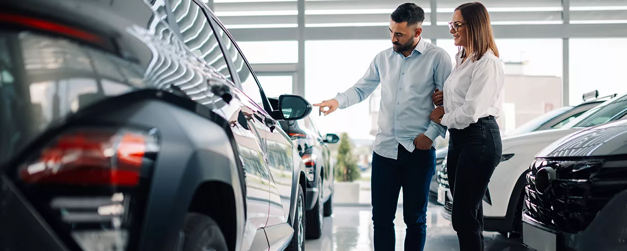A couple looking at a new Hyundai Vehicle displayed in the dealerships showroom