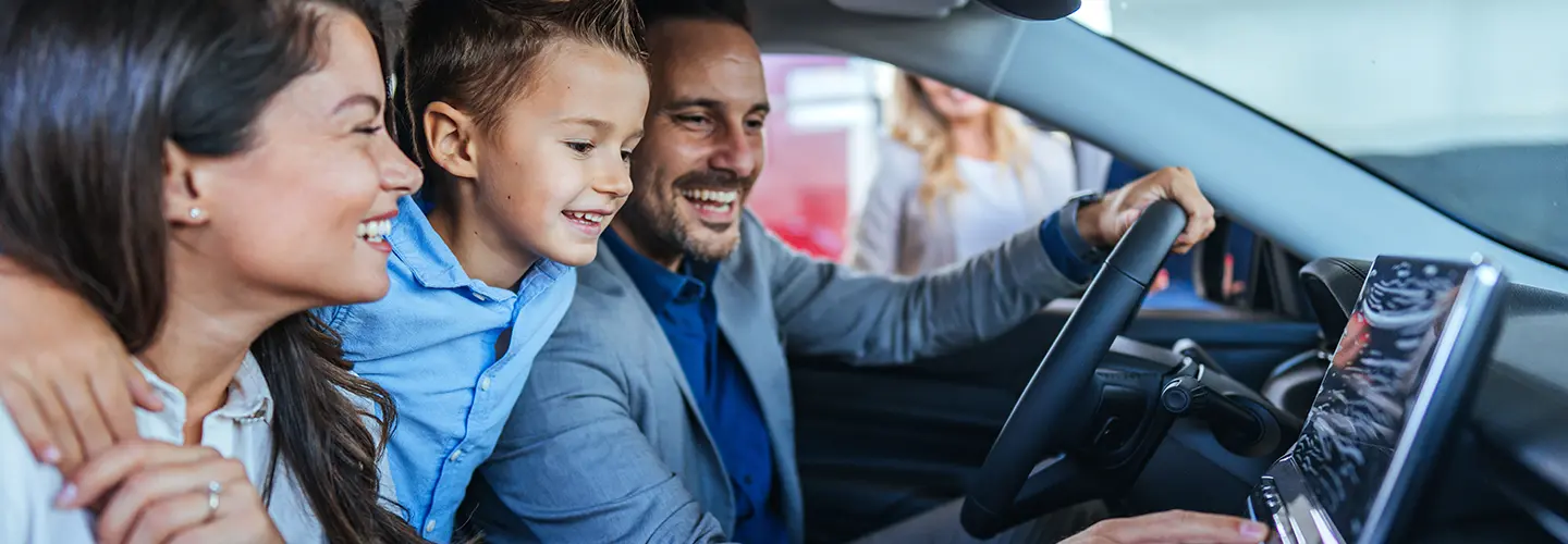 family inside new car
