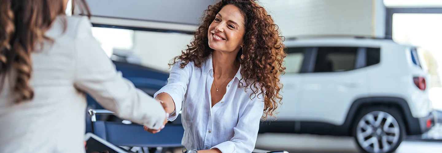 Customer and sales person shaking hands
