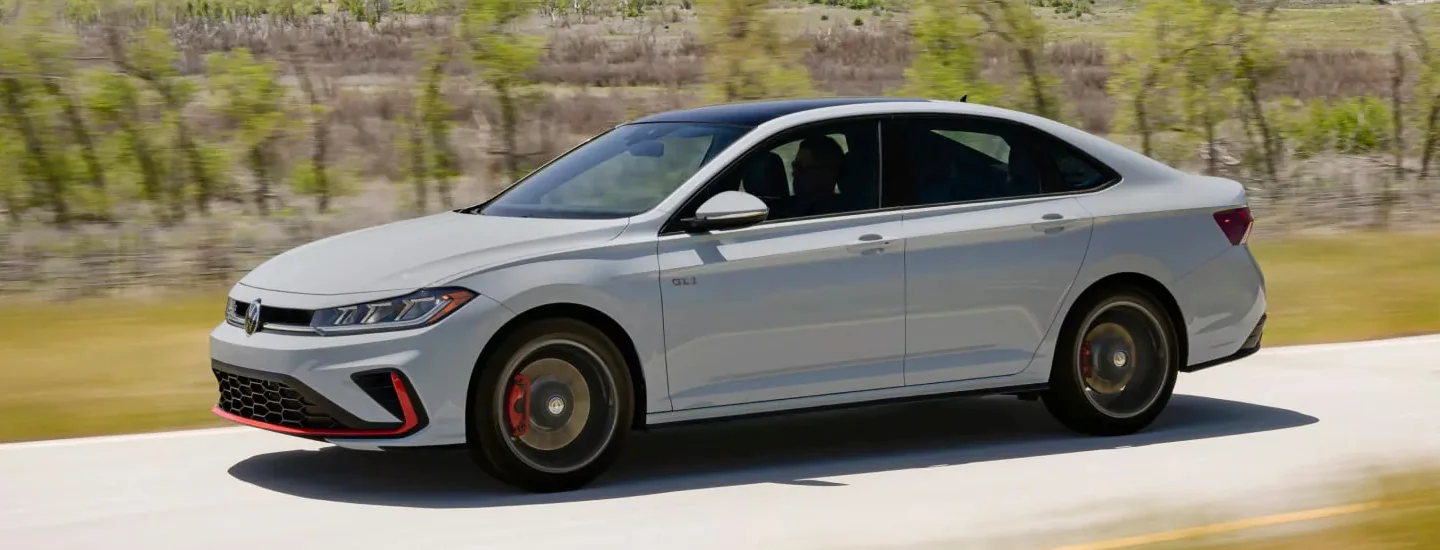 Gray 2024 Volkswagen Jetta GLI driving on a road