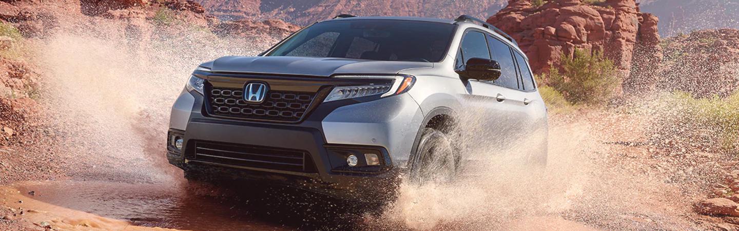 2021 Honda Ridgeline driving across creek with water spraying