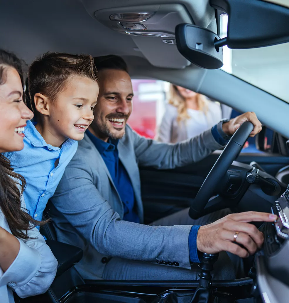 Family sitting inside a new kia vehicle