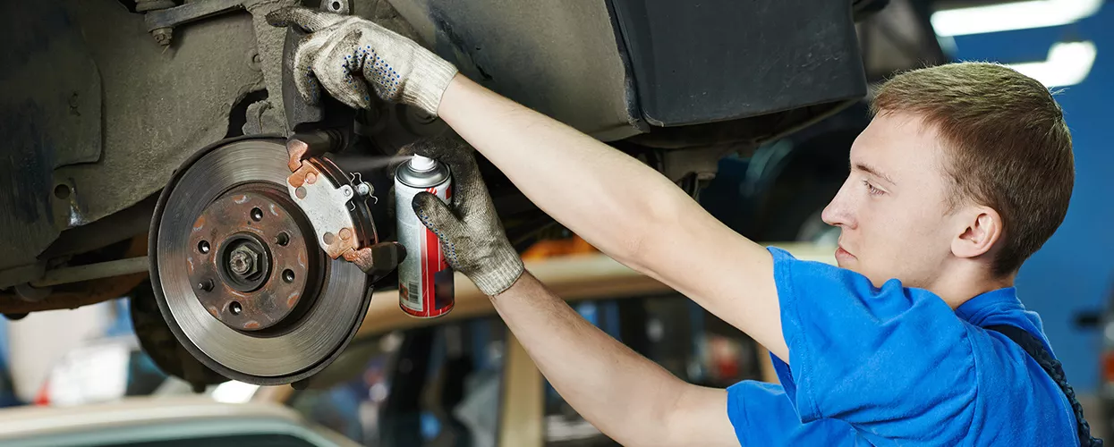 Service mechanic servicing brakes on a vehicle
