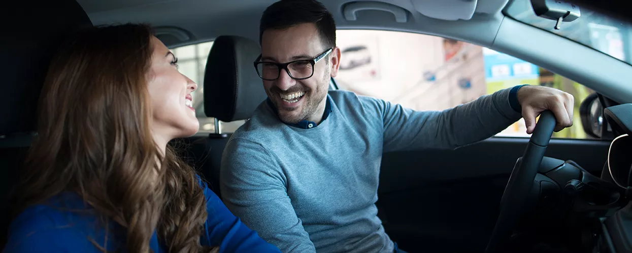 Couple in a new kia vehicle