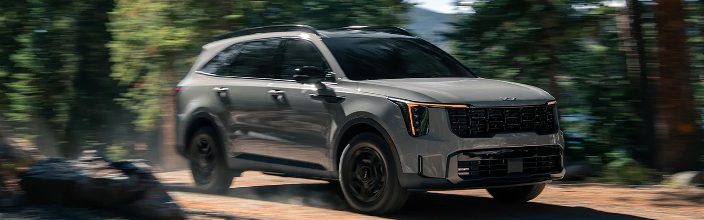 2024 Kia Sorento vs Jeep Grand Cherokee front side in brown