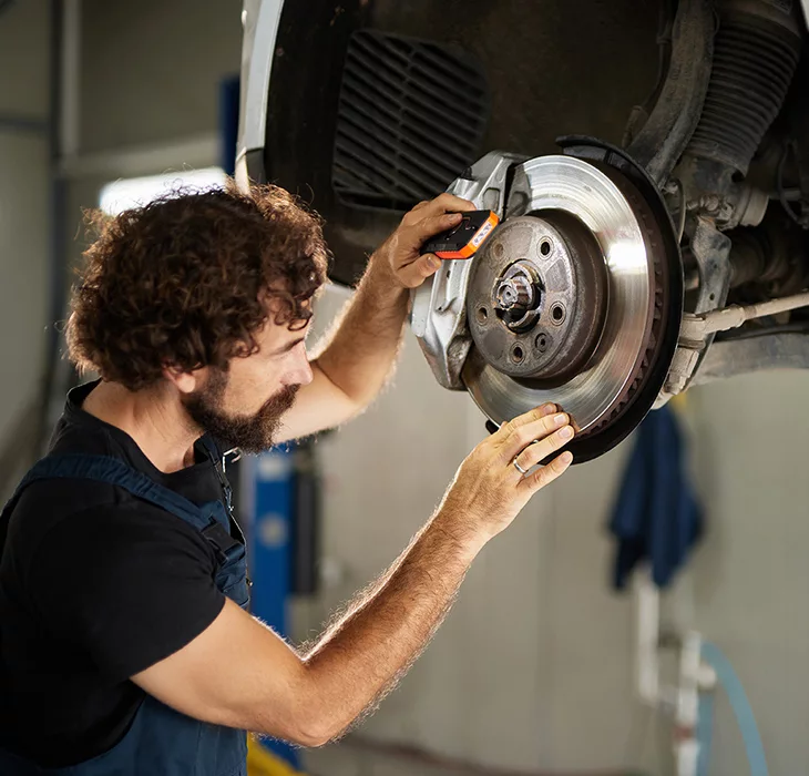 Technician servicing a vehicle
