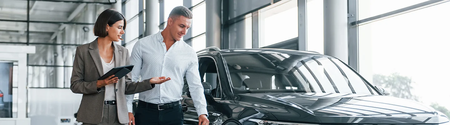 Car salesman with a customer at BMW of Pompono