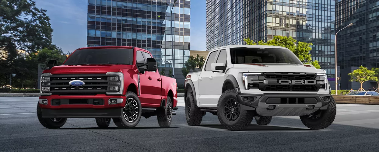 Two Ford trucks parked next to each other