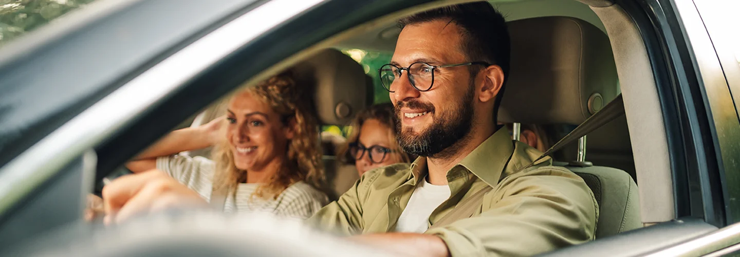 group of people smiling in car