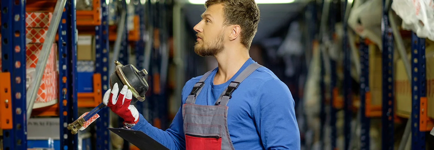 part person looking for a part with shelves of parts in view