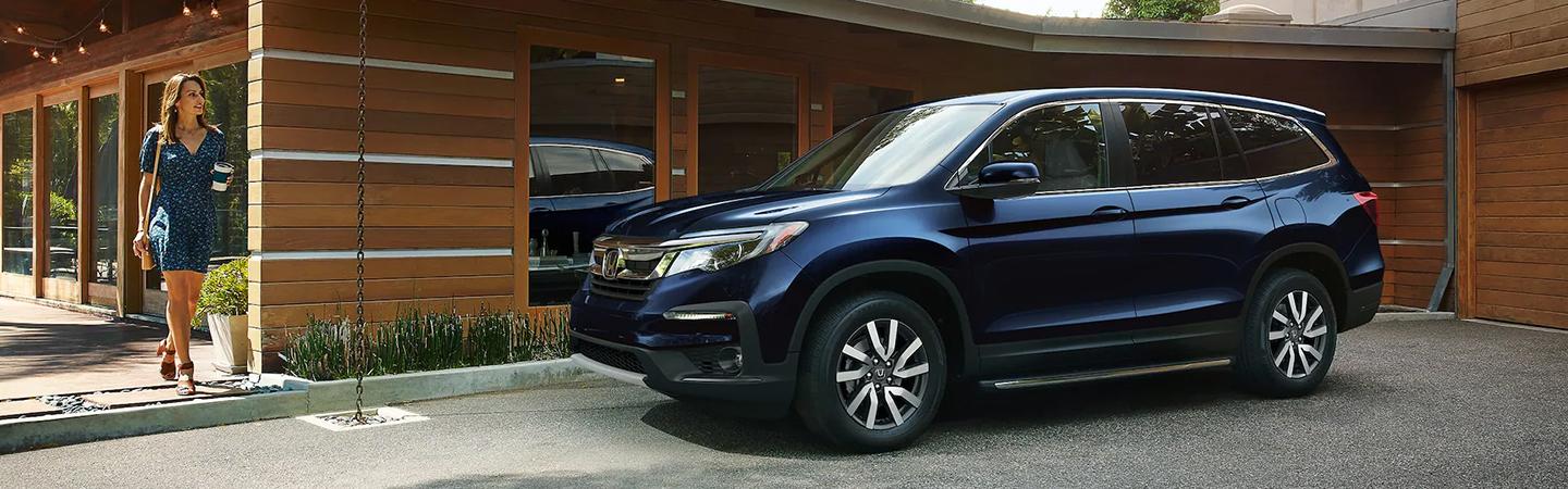 Honda Pilot is parked in front of the building
