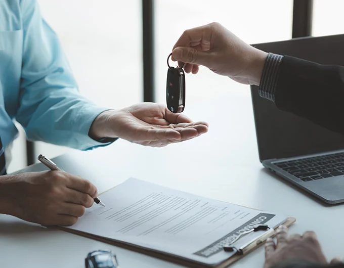 BMW Salesman giving car keys to buyer