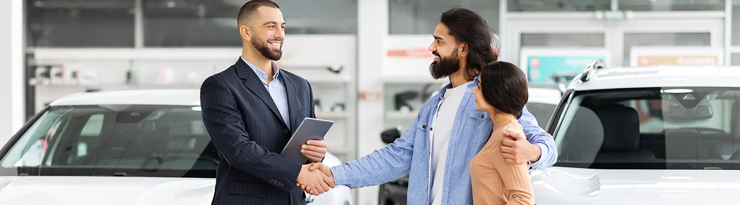 people shopping in car showroom
