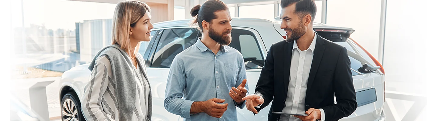 people shopping in car showroom