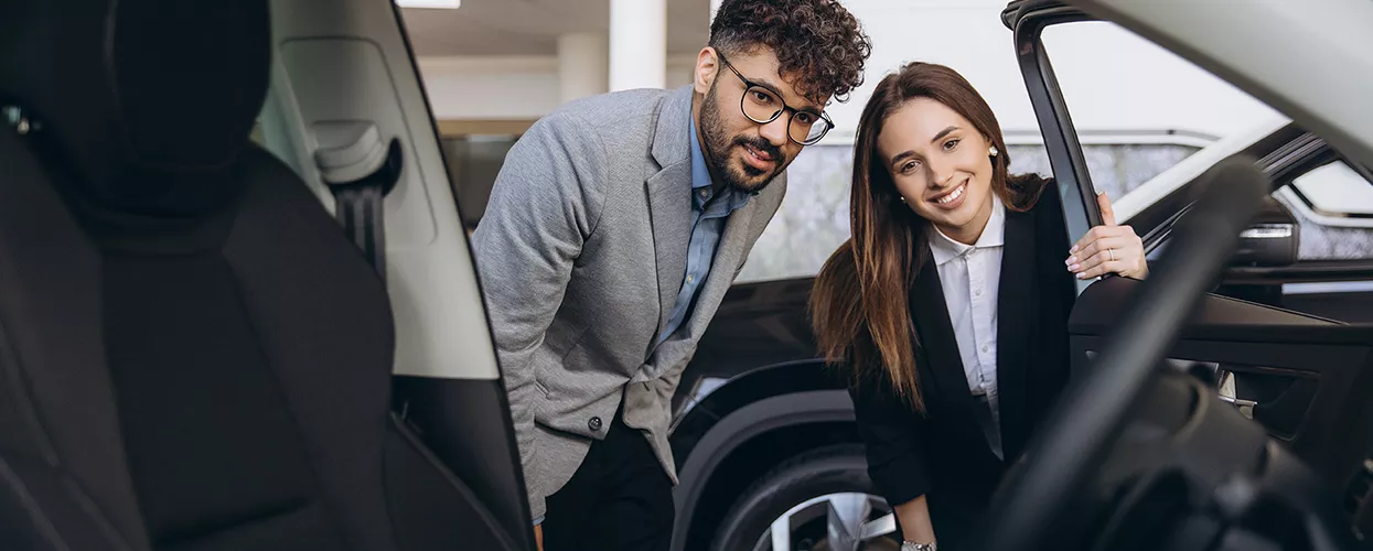 Customer discussing MINI lease options with an advisor at a dealership