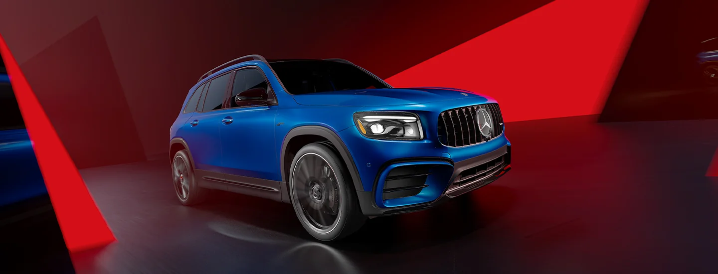 Front angle view of the 2025 Mercedes-Benz GLB with an abstract colored background