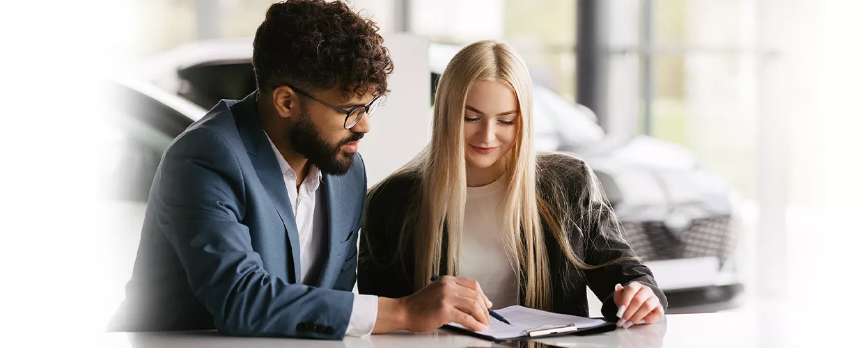 Customer discussing lease and finance options with an advisor at a Chevrolet dealership