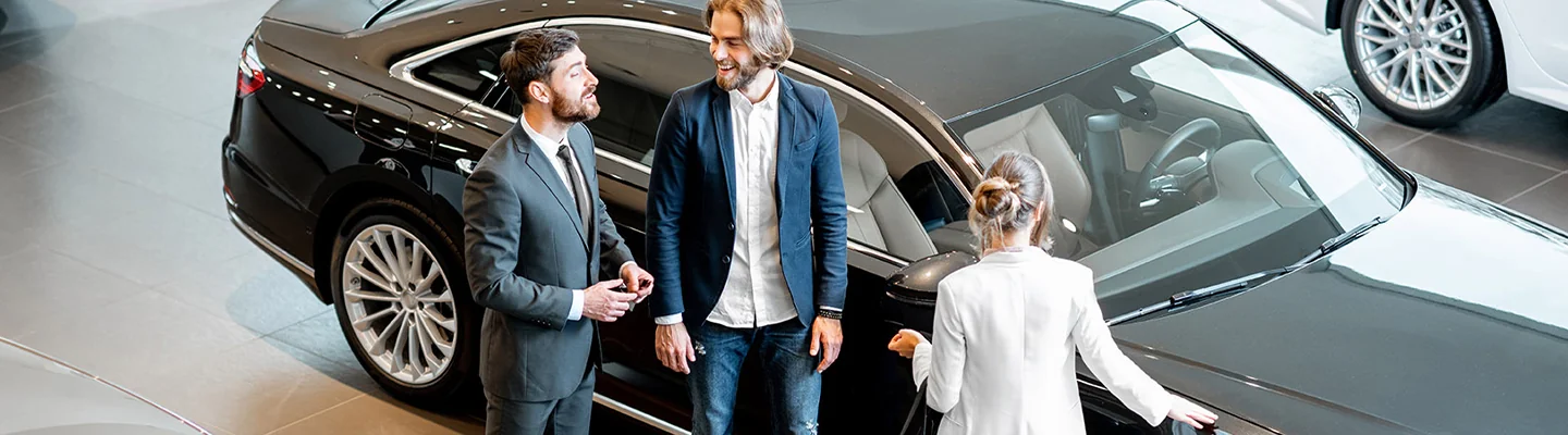 two people discussing car leasing terms in the dealership