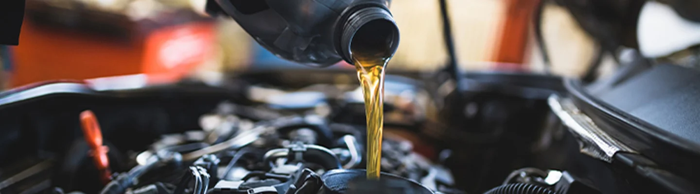 pouring oil in engine