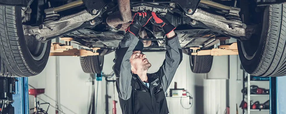 Service working on car on lift
