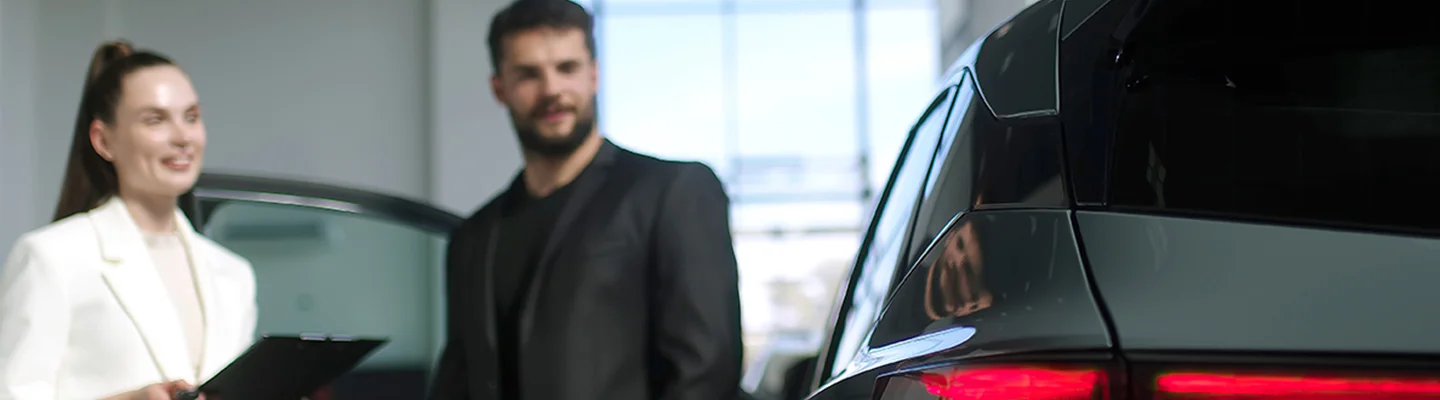 people shopping in car showroom