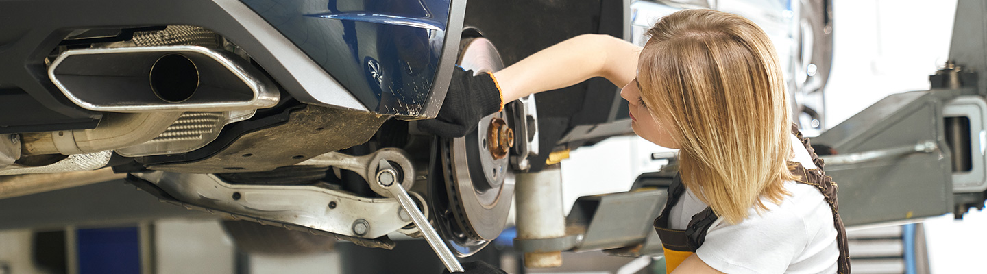 A service technician working on a vehicle’s brakes