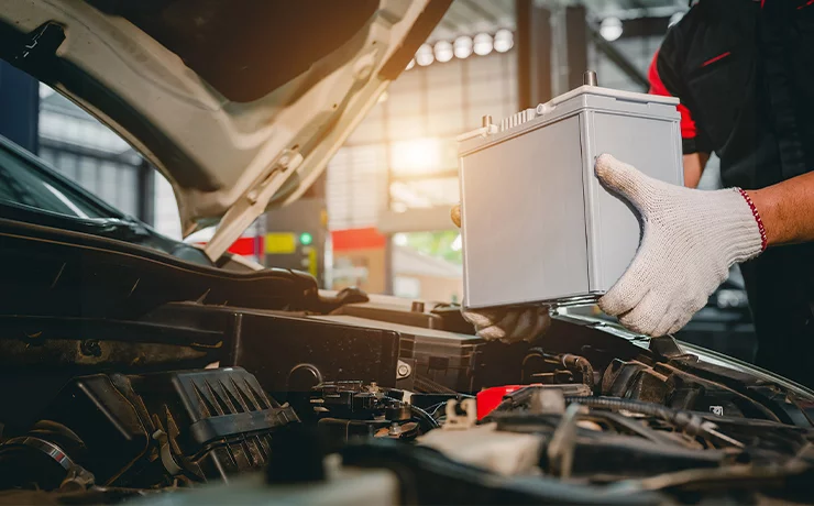 tech checking car battery