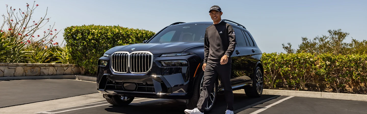 golfer walking beside a 2026 BMW X7 xDrive40i