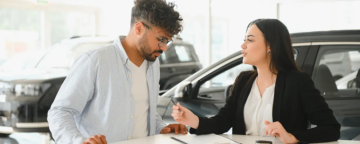 2 people car shopping in showroom