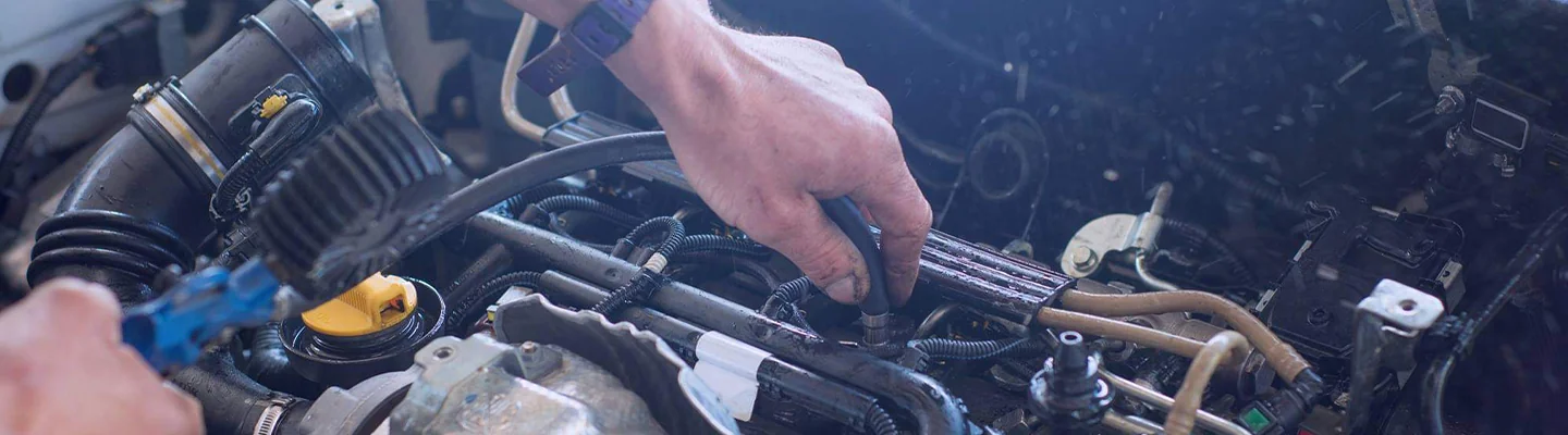 Mechanic changing the oil on a vehicle