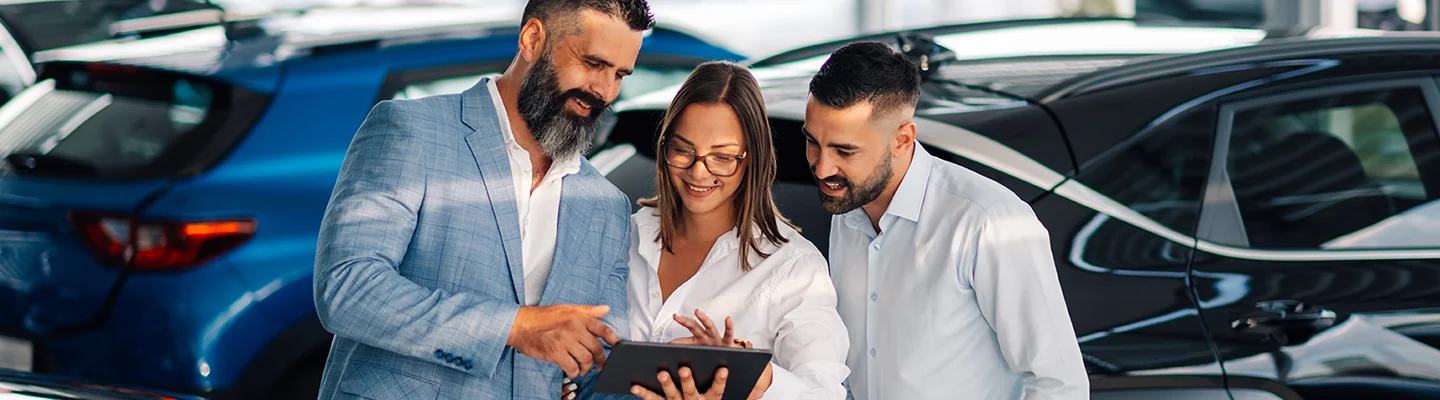 Car salesman showing a customer information about a Chevrolet vehicle