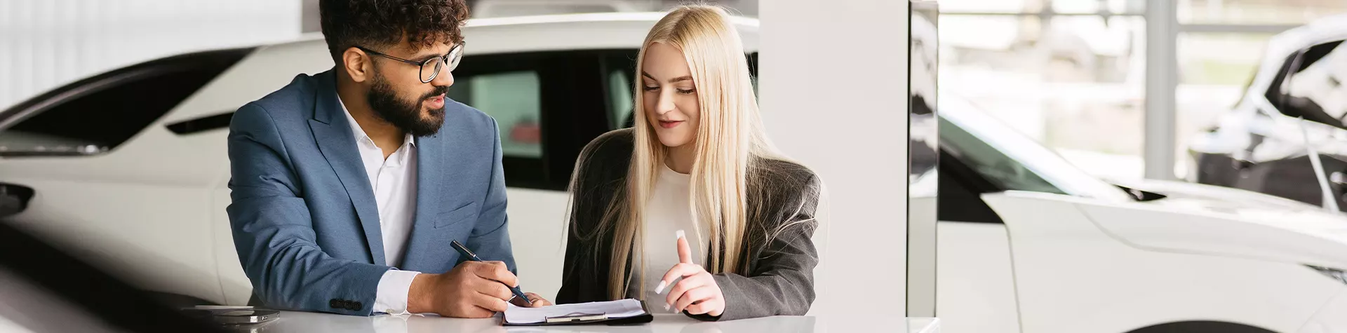 Sales person going over buying vs leasing options with a customer