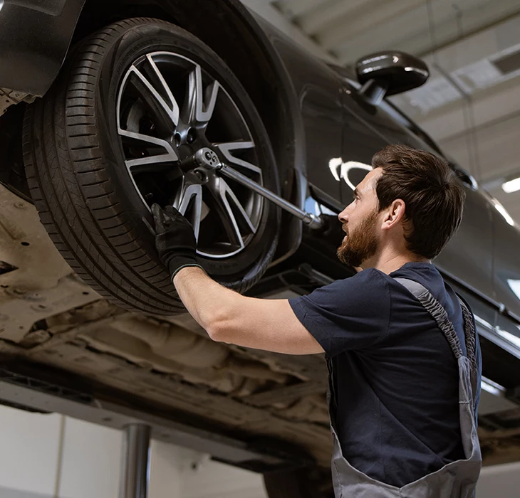 Technician servicing a vehicle