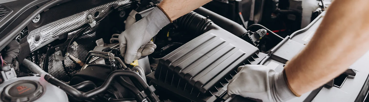 car mechanics hands over an engine