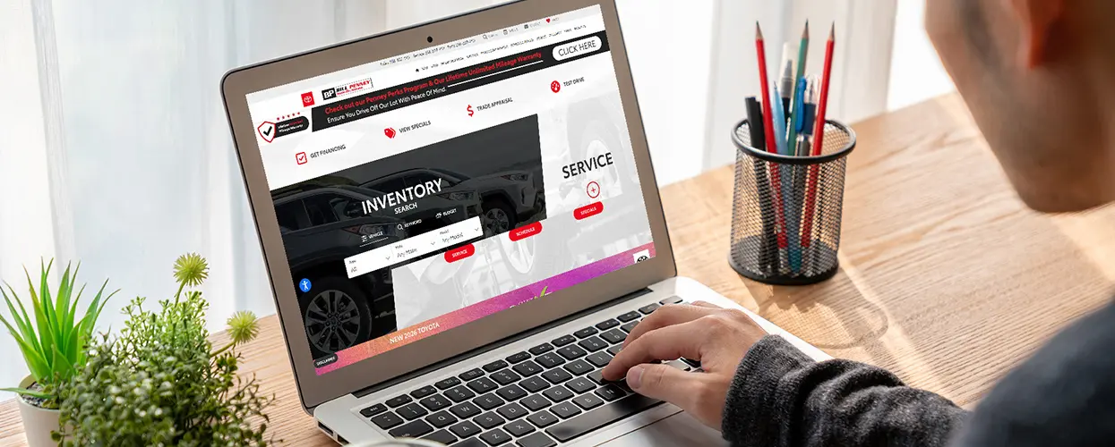 user on laptop searching for a new vehicle at Bill Penney Toyota