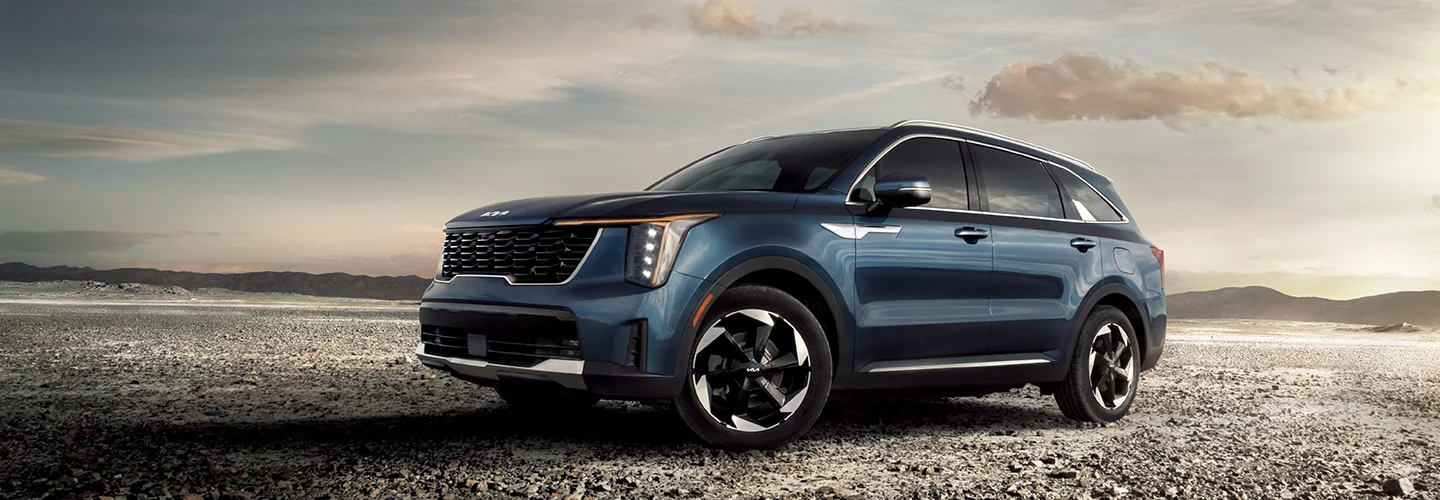 a blue 2025 Kia parked offroad