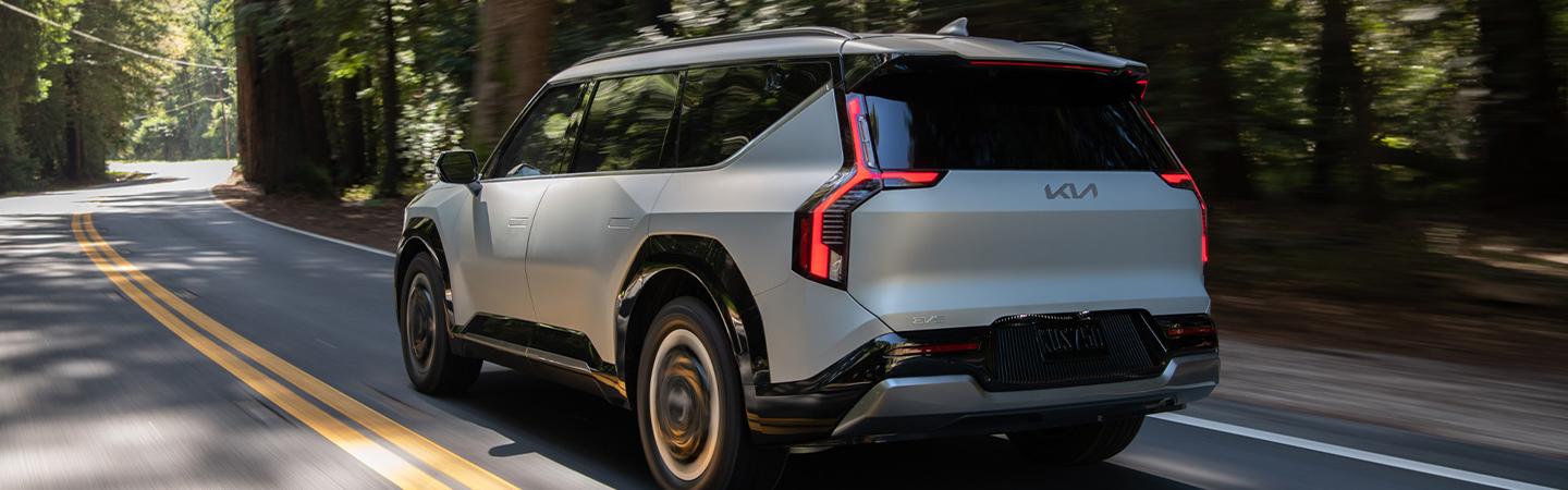 Back side view of a 2024 Kia EV9 driving