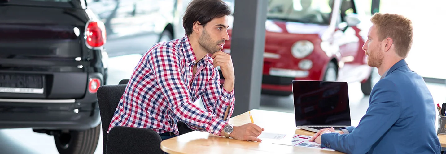 Salesperson speaking with a customer at a table