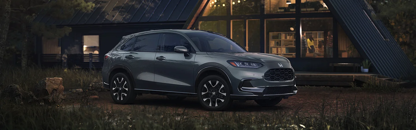 Side view of a gray 2026 Honda HR-V parked next to a cabin