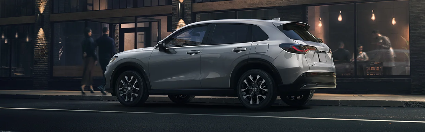 Side view of a parked gray 2026 Honda HR-V on a city street
