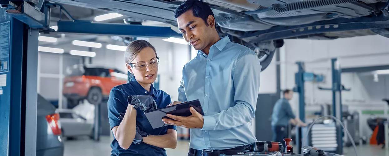 Service mechanics looking over a tablet