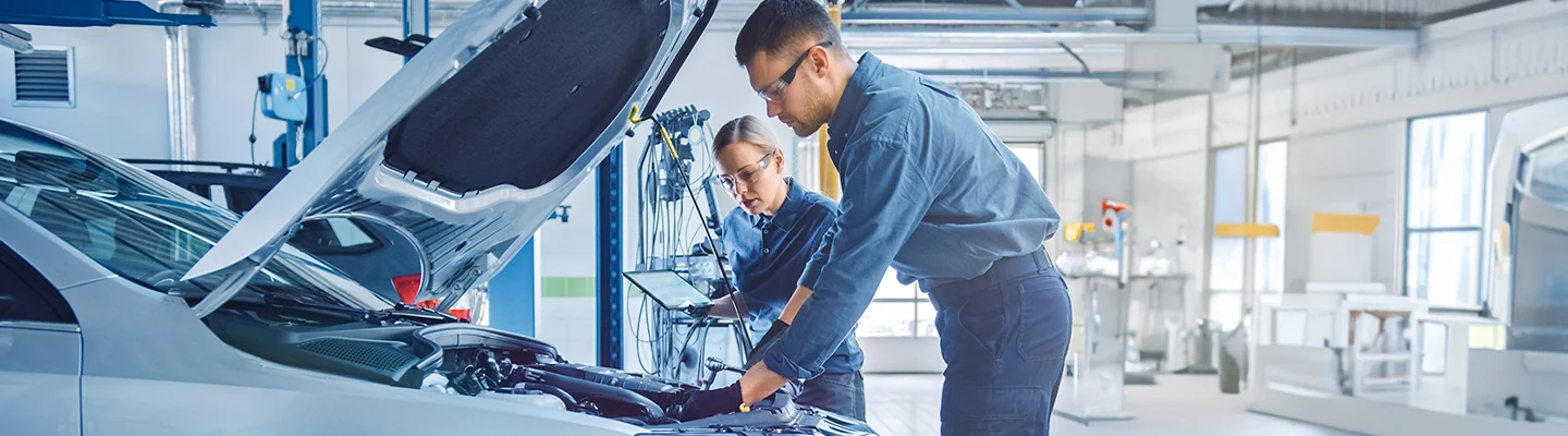 Service technicians working on a vehicle at Honda of Lake City
