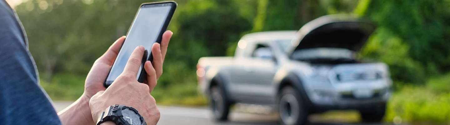 a person using their phone to call for service