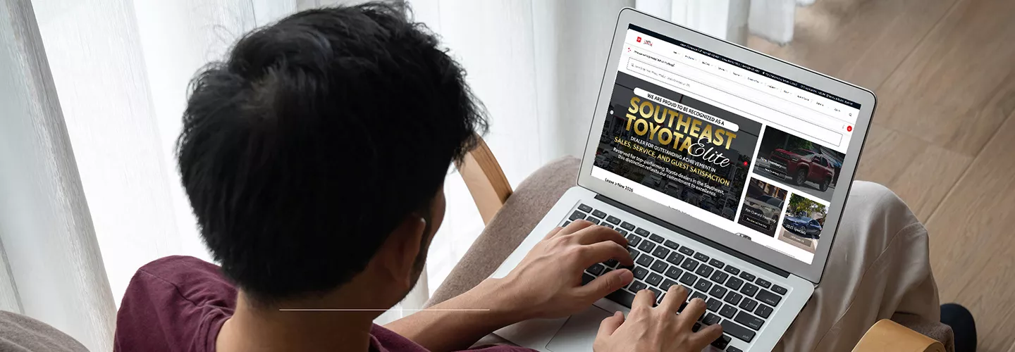 Person using thier laptop to view the Toyota of Tampa Bay website