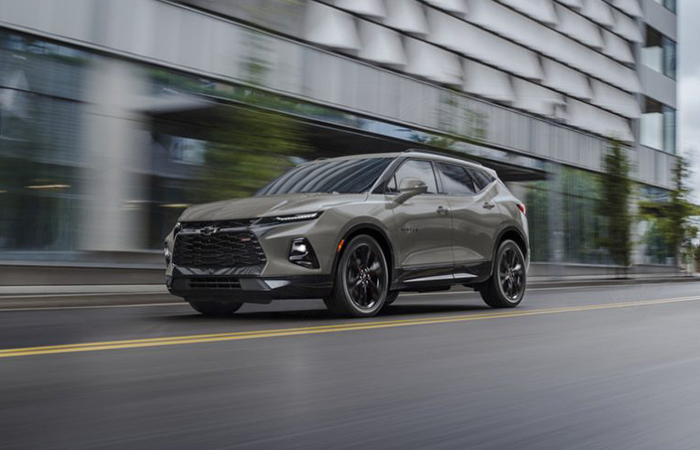 Angled profile of a gray Chevy Blazer in motion