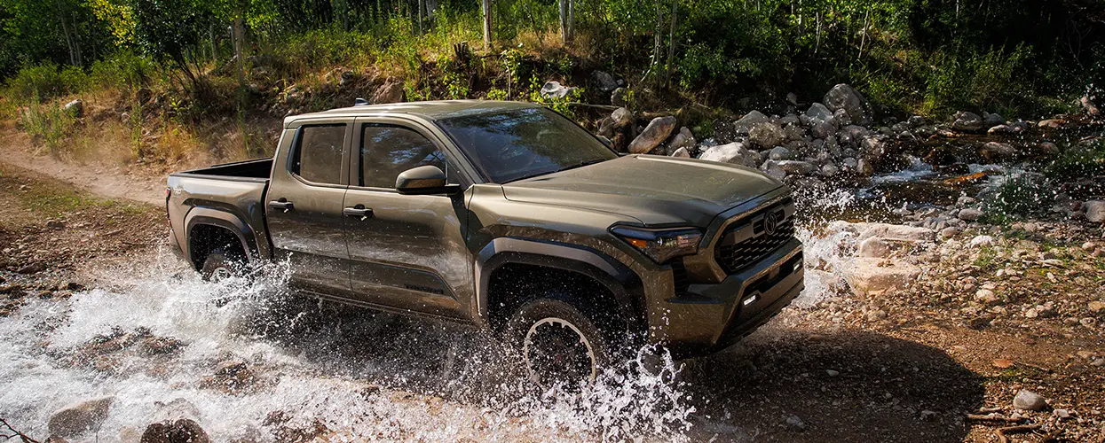 toyota truck going through large puddle