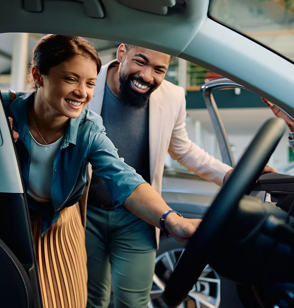 Family reviewing electric SUV technology with a Villages Subaru sales associate